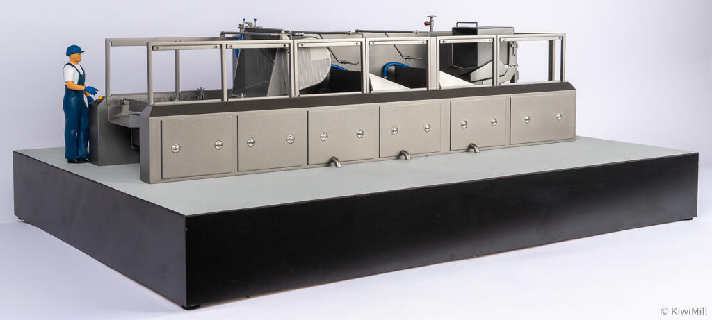Low three-quarter view of the open cooking line model, with drain spouts below the six-panel tank cabinet